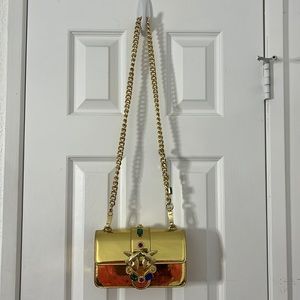 Bejeweled gold shoulder strap purse